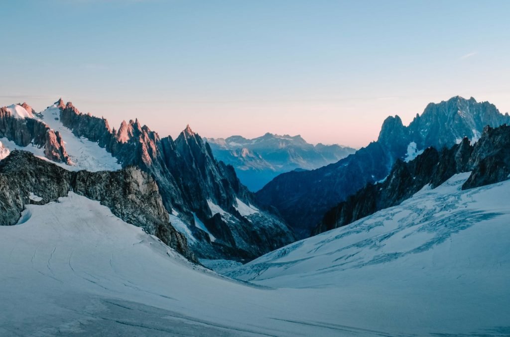 photo of snow capped mountains during dawn