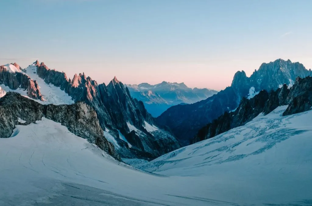 photo of snow capped mountains during dawn